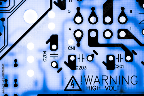 WARNING HIGH VOLT Close up of Electronic Circuits in Technology on Mainboard background (Main board,cpu motherboard,logic board,system board or mobo)