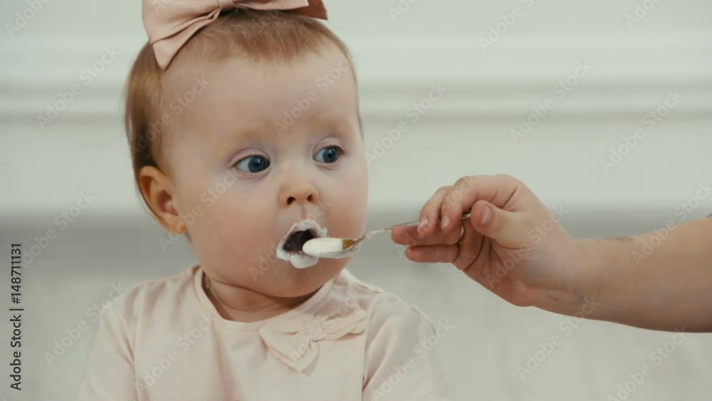 older sister feeds her funny baby sister older sister feeds her funny baby sister