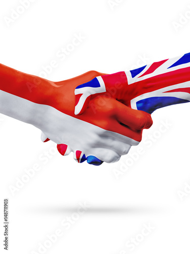 Flags Monaco, United Kingdom countries, partnership friendship handshake concept. photo