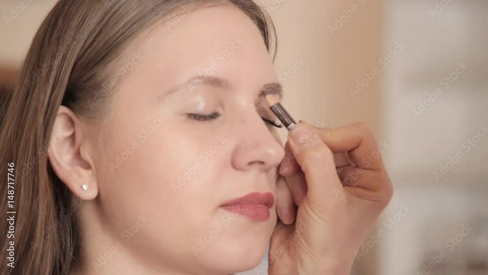 make-up artist drawing eyebrows of client by pencil. Close up shot. make-up artist drawing eyebrows of client by pencil. Close up shot.