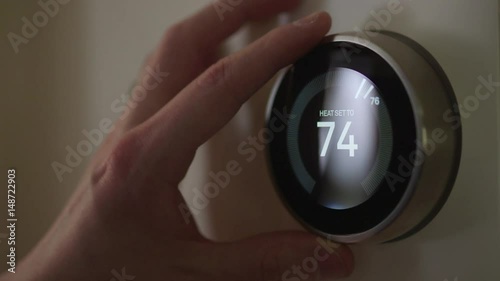 Man Adjusting Smart Thermostat Gadget At Home