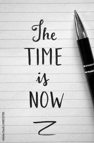 Handwritten quote on notepaper “THE TIME IS NOW”