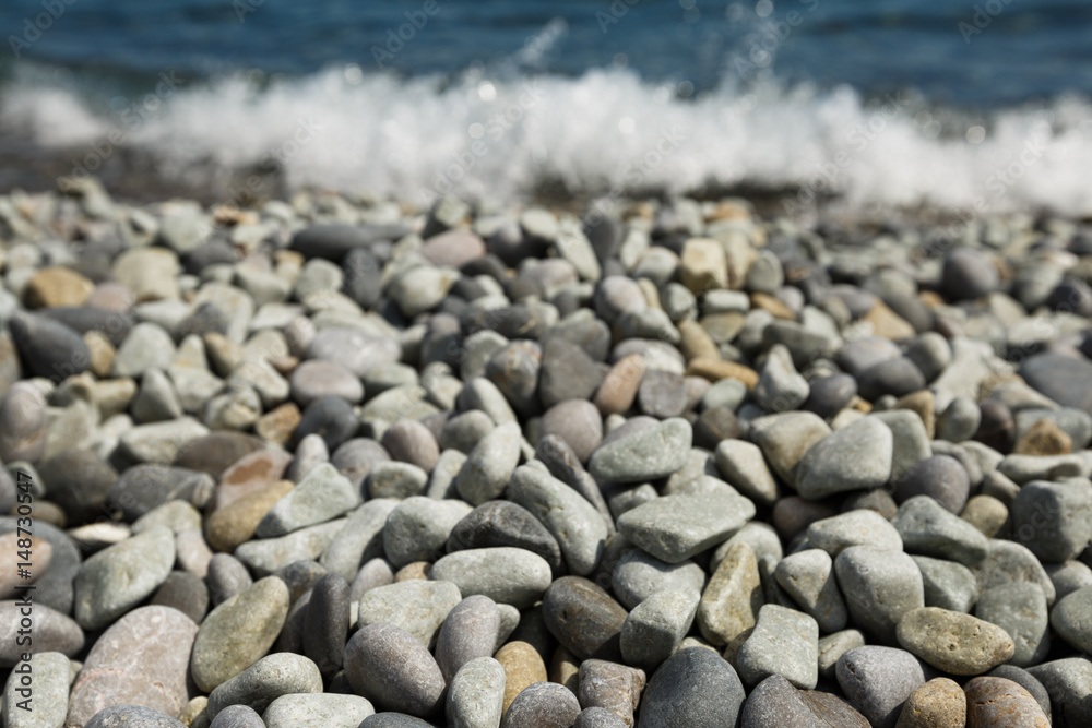 Pebble stones and with tidal bore of sea on background Pebble stones and with tidal bore of sea on background