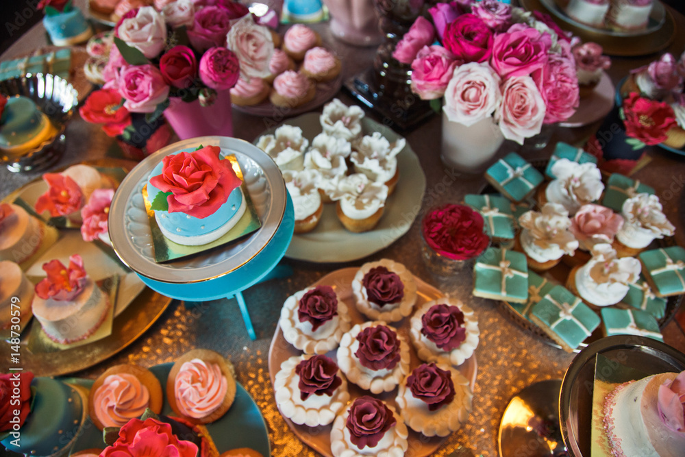 Pink, white and blue floral cakes served on little plates