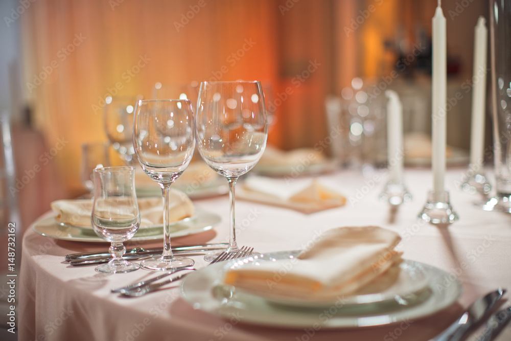 Sparkling glasses stand by plate on dinner table