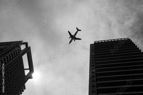 Aircraft traveling over city building, high skyscrapers