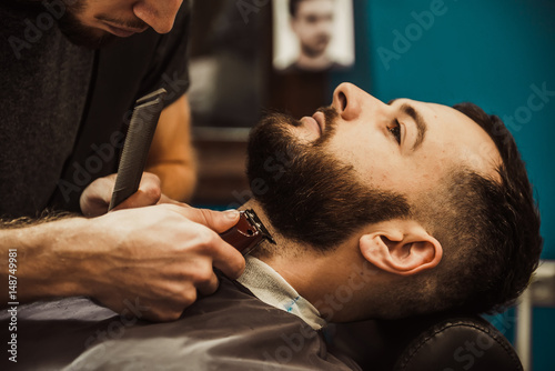 Barber's beard cuts a hipster © sergo321