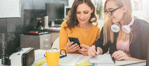 Two business woman working together at the office photo