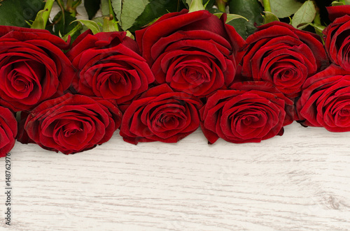 Top view of a bouquet of red roses, close-up, white background, space for text