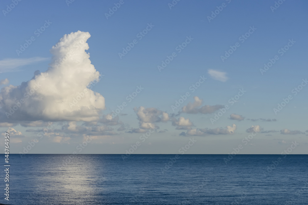 Distant clouds on calm sea.
