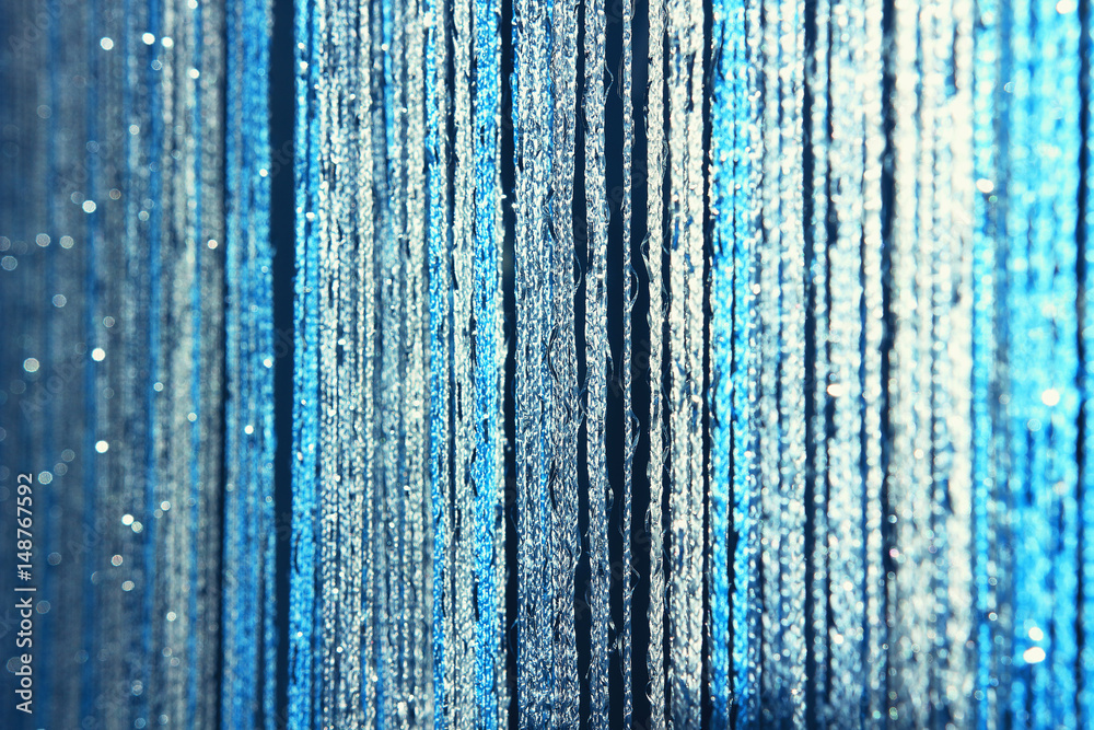 Fototapeta premium Background texture curtains made of blue threads with glitter and blur at the edges.