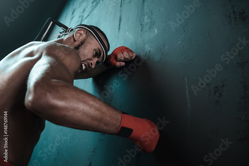 Muay Thai athlete training at Thai boxing indoors, ultimate fight concept © LIGHTFIELD STUDIOS