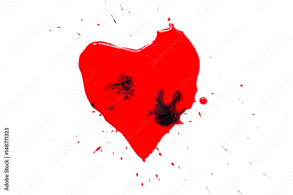 Heart symbol painted with red paint with black drops and spatter and splash around isolated on white background