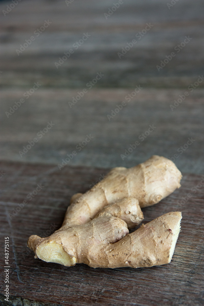 raw ginger root on rustic wooden background. raw ginger root on rustic wooden background.