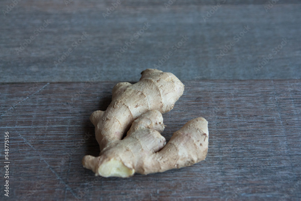 raw ginger root on rustic wooden background. raw ginger root on rustic wooden background.