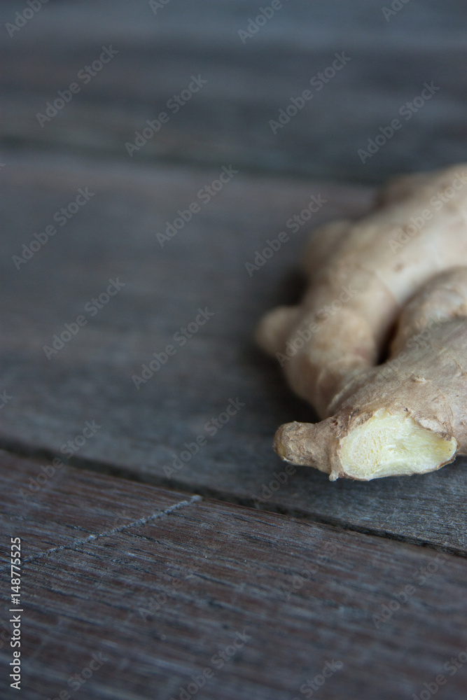 Fototapeta premium raw ginger root on rustic wooden background.