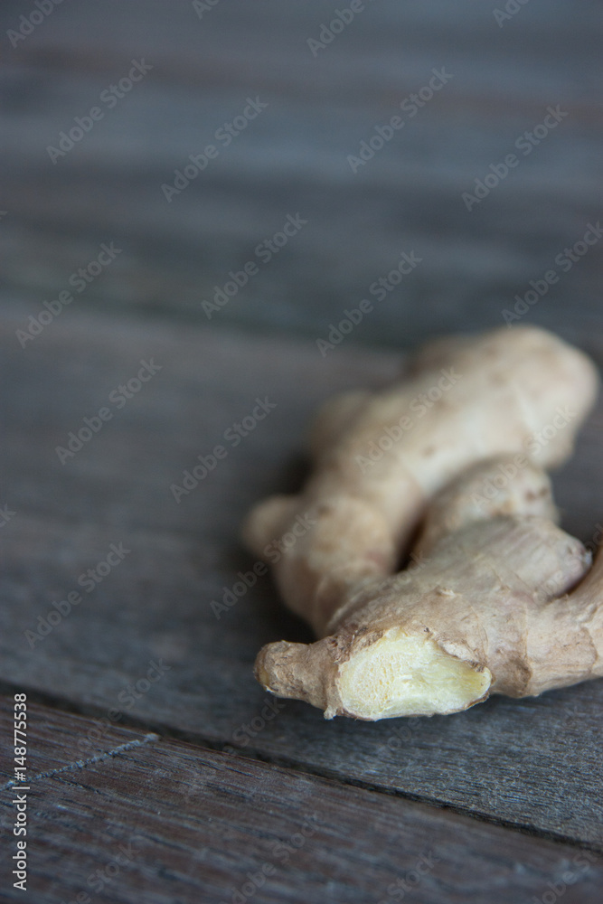 Fototapeta premium raw ginger root on rustic wooden background.