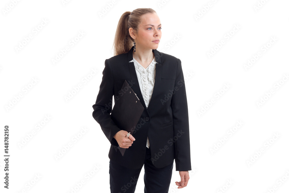 a beautiful young woman in a black business suit looks away and keeps the Tablet a beautiful young woman in a black business suit looks away and keeps the Tablet