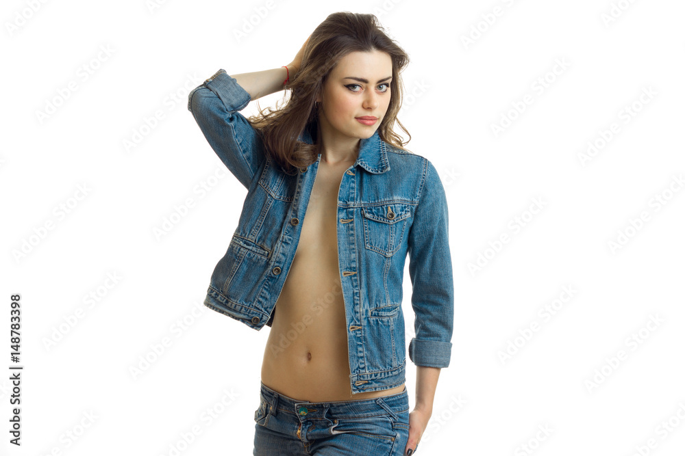 beautiful young girl in denim jacket with a naked belly poses on camera  Stock Photo | Adobe Stock