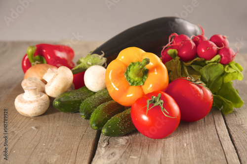 Composition with assorted raw organic vegetables wooden table