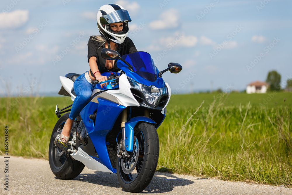 Portrait of a beautiful woman and a motorcycle of speed Portrait of a beautiful woman and a motorcycle of speed
