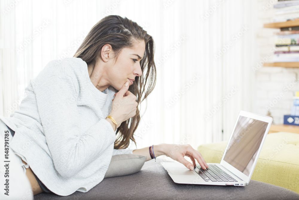 Morning scene. Beautiful woman using laptop at home Morning scene. Beautiful woman using laptop at home