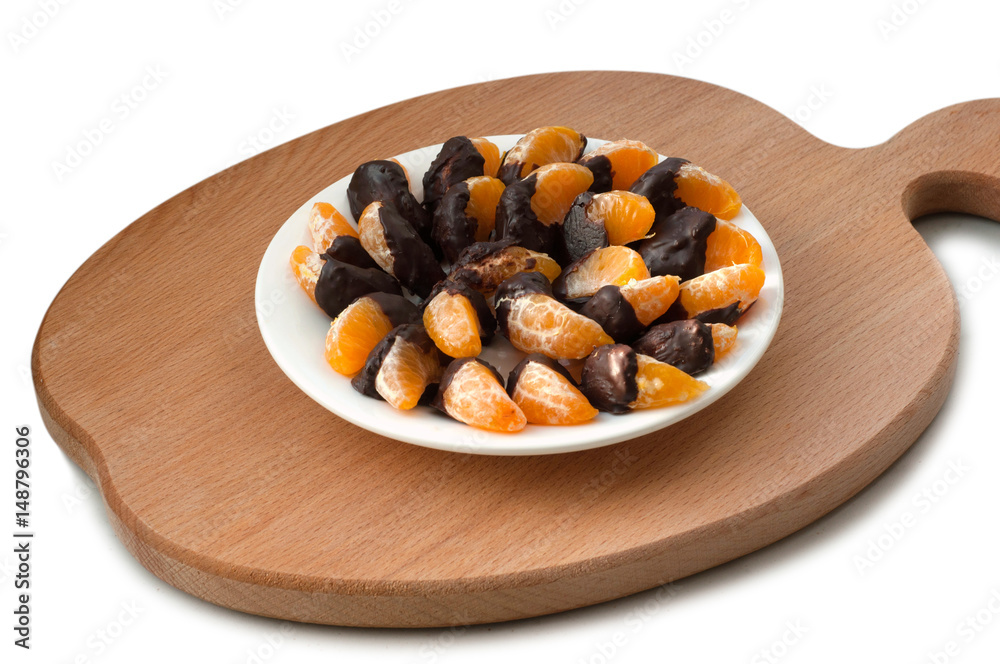 Slices of tangerine in chocolate on wooden cutting board Slices of tangerine in chocolate on wooden cutting board