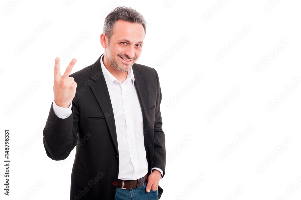 Handsome young man showing victory fingers sign Handsome young man showing victory fingers sign