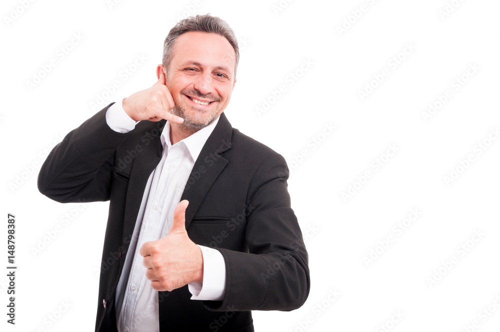 Cheerful smiling man making call me gesture Cheerful smiling man making call me gesture