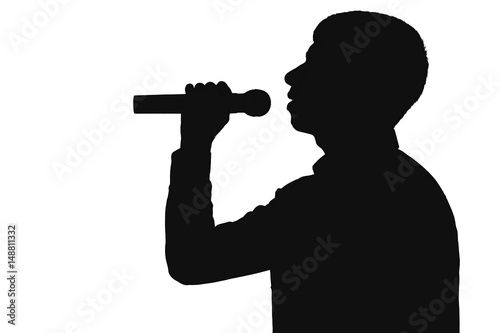 Silhouette profile of a man singing into a microphone