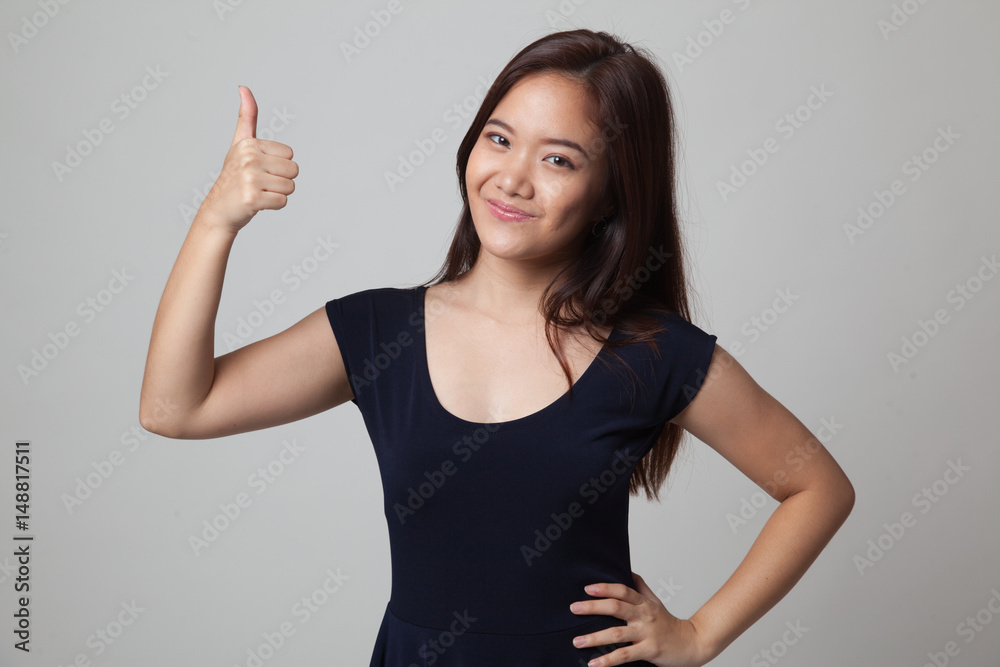 Young Asian woman show thumbs up. Young Asian woman show thumbs up.