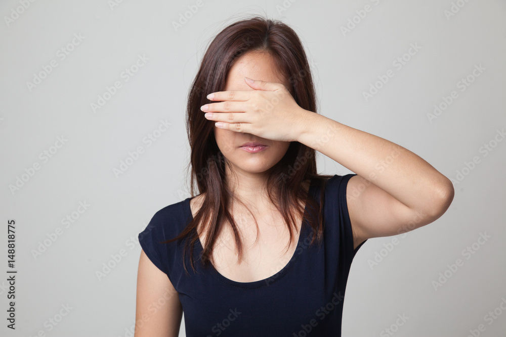 Young Asian woman close her eyes with hand. Young Asian woman close her eyes with hand.