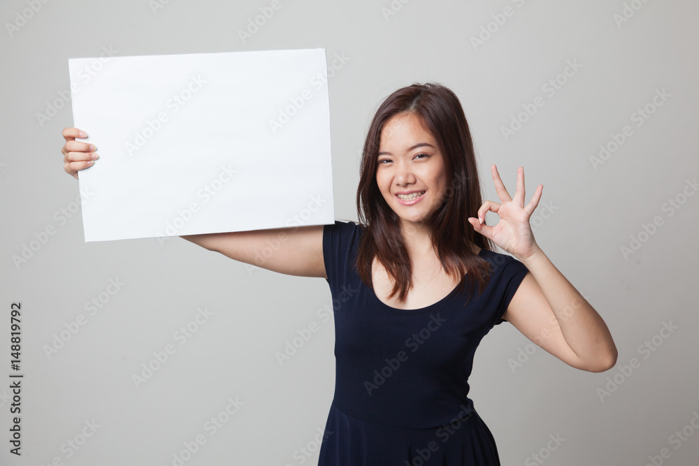 Young Asian woman show OK with  white blank sign.