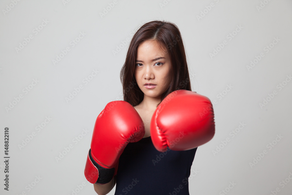 Young Asian woman with red boxing gloves. Young Asian woman with red boxing gloves.
