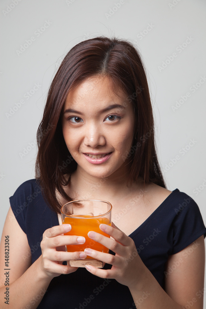 Young Asian woman drink orange juice. Young Asian woman drink orange juice.