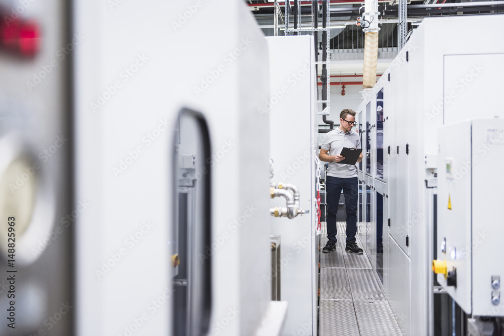 Man examining the system in factory Man examining the system in factory