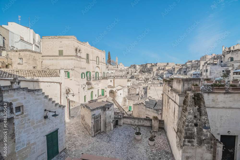 panoramic view of typical stones (Sassi di Matera) near gravina of Matera UNESCO European Capital of Culture 2019 on blue sky