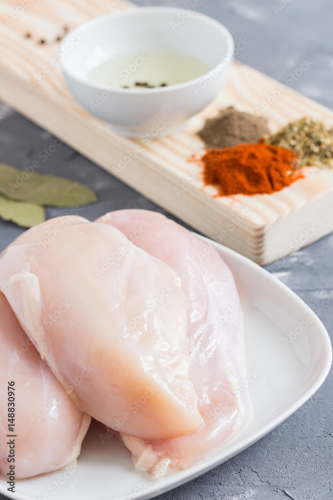 Chicken and ingredients for marinade. Preparing food. Chicken in marinade with herbs and spices. Ready for cooking. Chicken and ingredients for marinade. Preparing food. Chicken in marinade with herbs and spices. Ready for cooking.