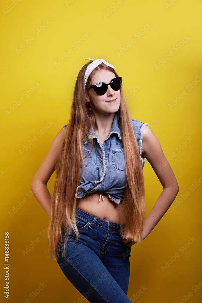 Fototapeta premium Long hair girl yellow background