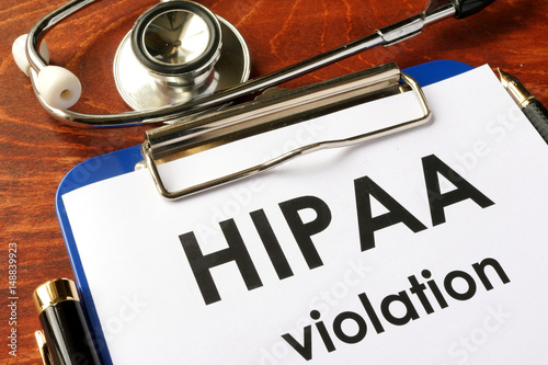 HIPAA violation form on a clipboard. Medical confidentiality concept.