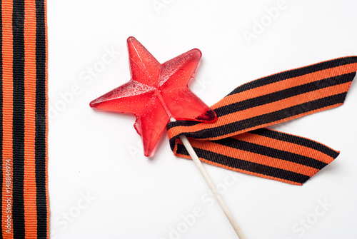 Candy in the shape of a star, a red candy on a stick, photo