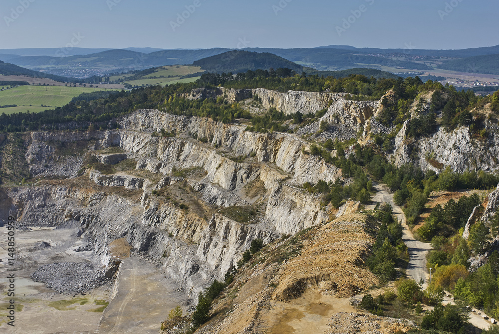 Limestone mine in Koneprusy, Czech Republic. Deep opencast mines leave great environmental impact.