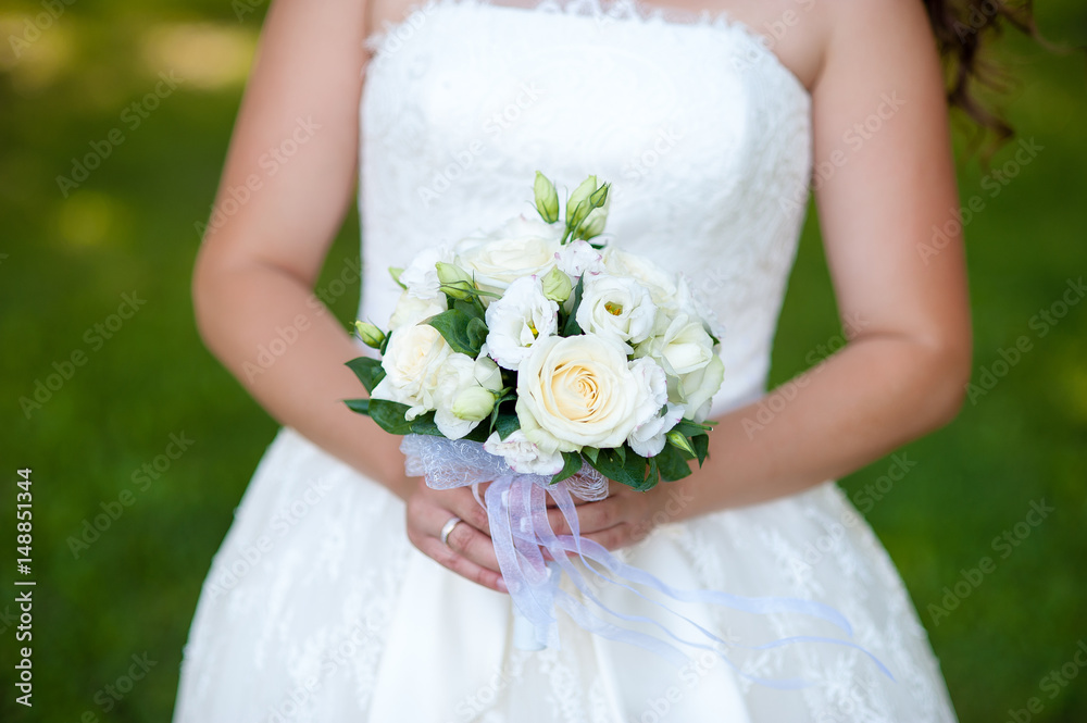 Wedding bouquet in the hands of the bride. Wedding bouquet in the hands of the bride.