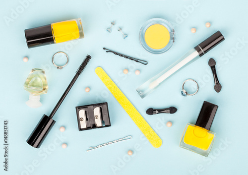 set of professional decorative cosmetics, makeup tools and accessory on blue background. beauty and fashion concept. flat lay composition, top view