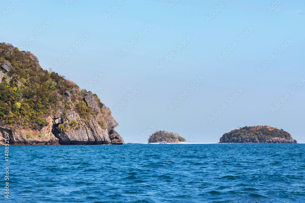 view of small island limestone rock in andaman sea under blue sky background at  krabi Thailand
