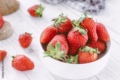 Fresh Strawberry in a bow on wooden table