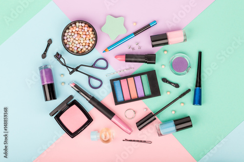 set of professional decorative cosmetics, makeup tools and accessory on multicolored background. beauty, fashion and shopping concept. flat lay composition, top view