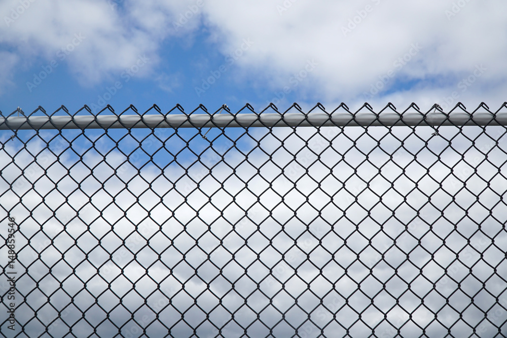 iron chain link fence against sky iron chain link fence against sky