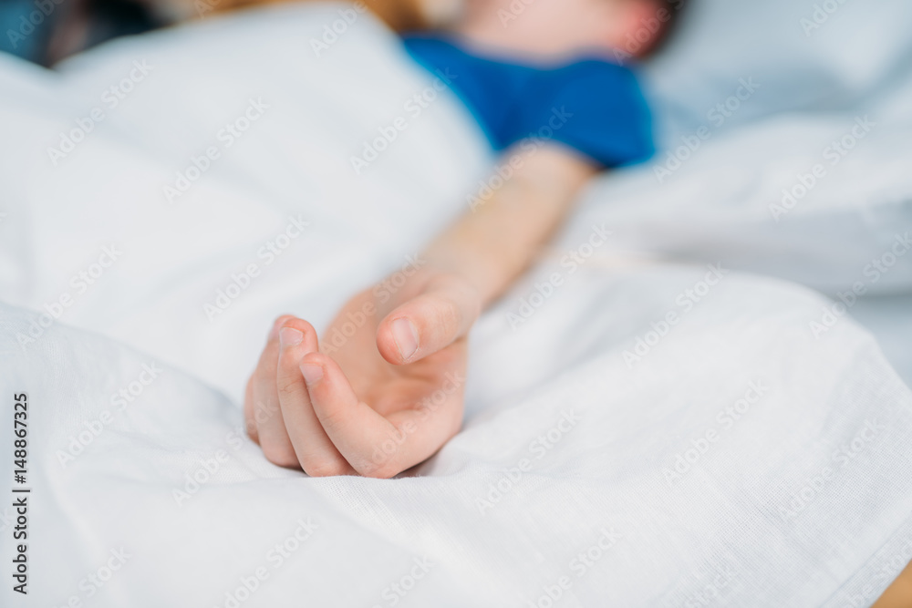 partial view of little boy lying in hospital bed partial view of little boy lying in hospital bed