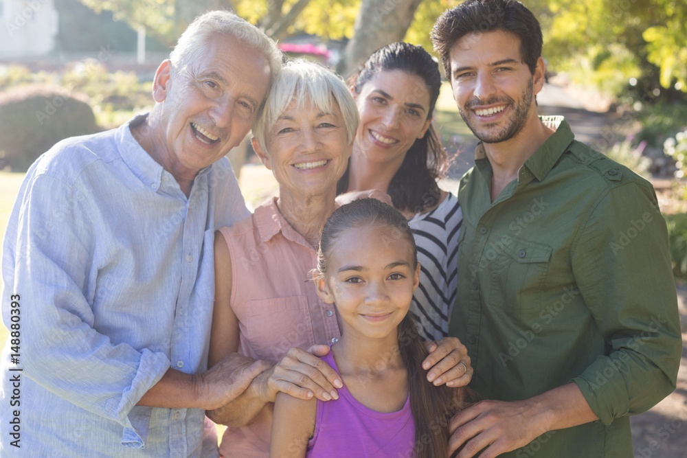 Happy family standing together in the park Happy family standing together in the park